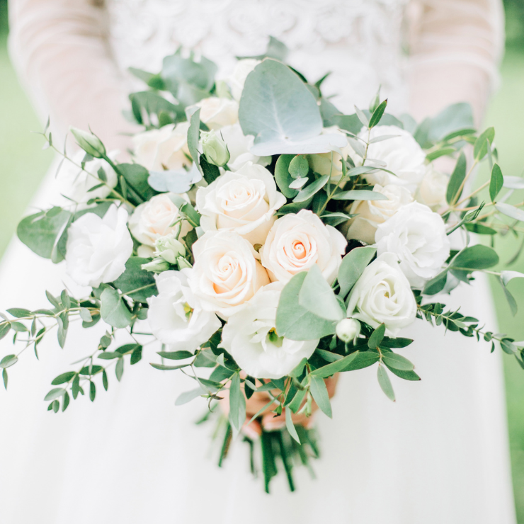 Sage green wedding bridal bouquet with roses and eucalyptus foliage.