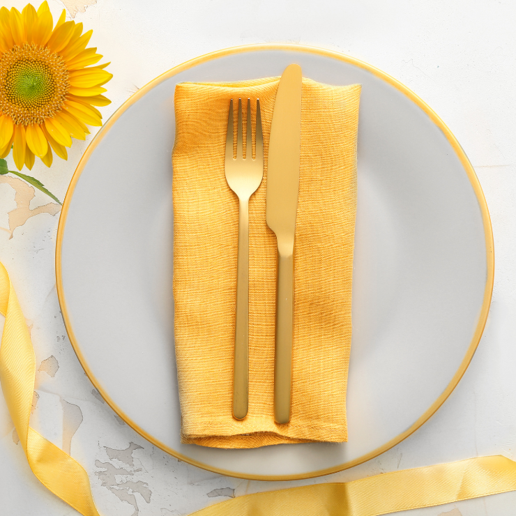 Bride to bee bridal shower cutlery setting with yellow napkin, gold cutlery and sunflower.