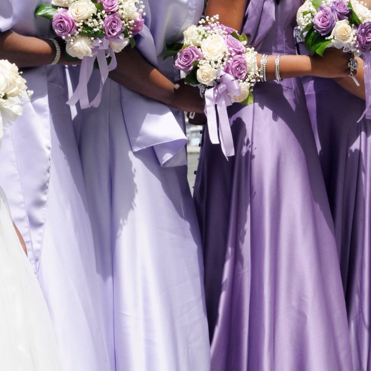 Dusty mauve wedding bridesmaids with rose bouquets.