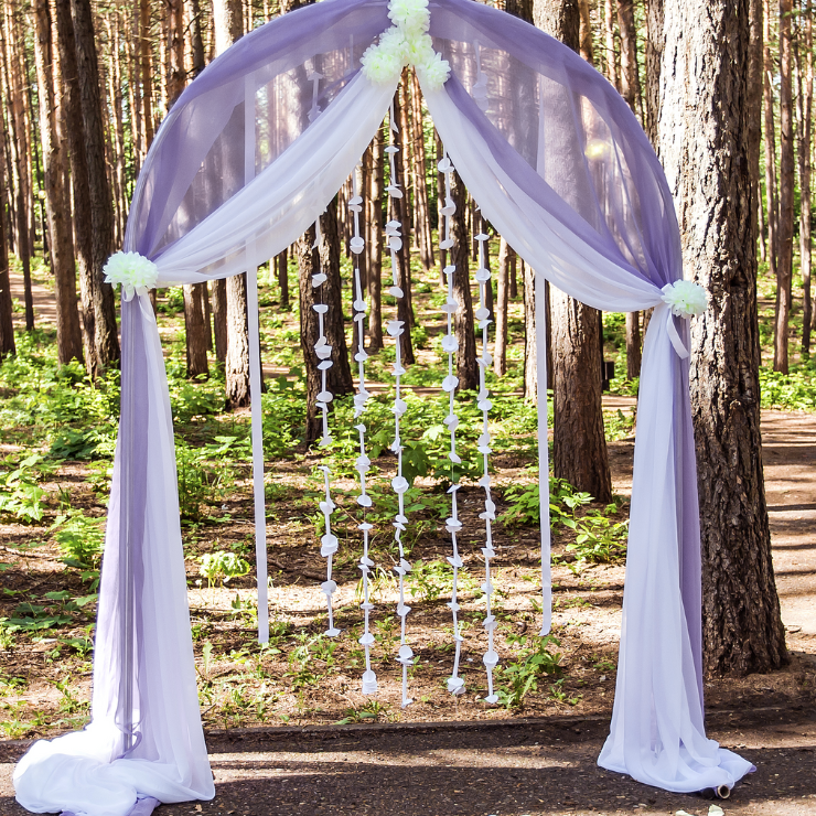 Dusty mauve wedding arbor with silky mauve fabric.