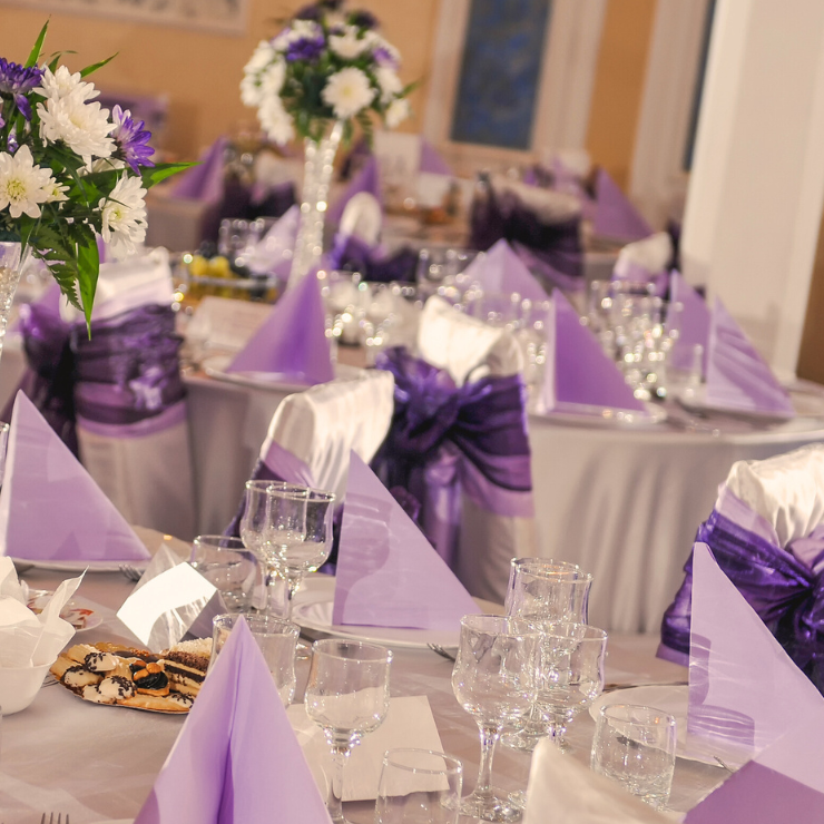 Dusty mauve wedding reception tables with mauve chair sashes and napkins.