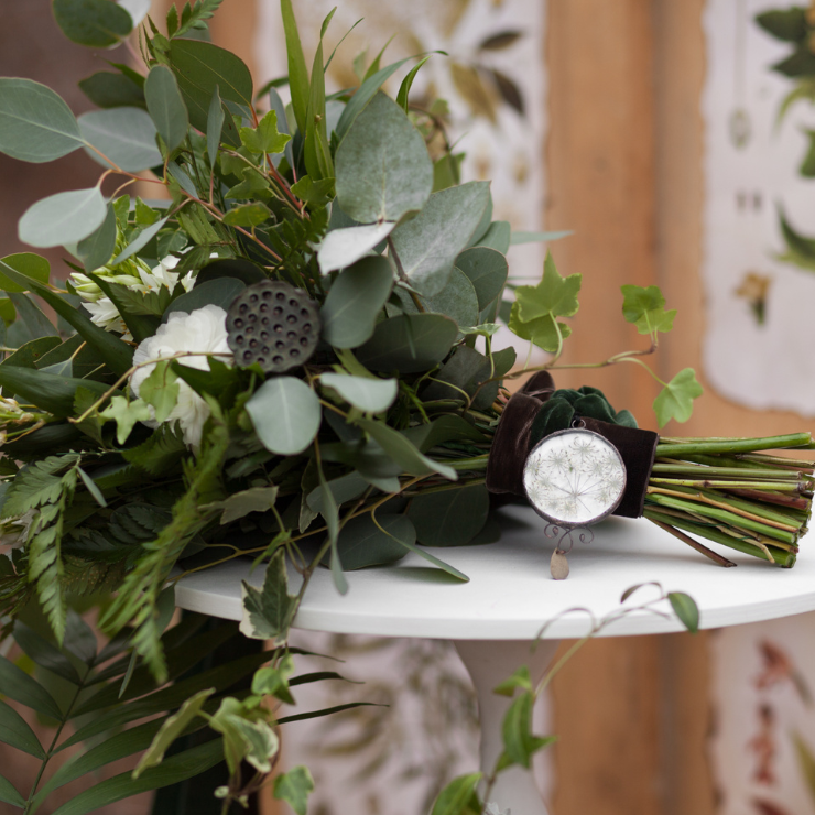 Sage green wedding bridal bouquet with flowing green foliage, eucalyptus leaves and white flowers.