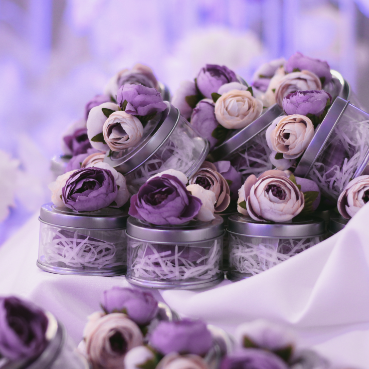 Dusty mauve wedding favor jars adorned with vintage style mauve roses and rose buds.