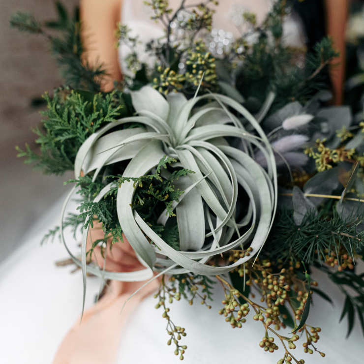 Sage green wedding bridal bouquet in modern style with sage green foliage.