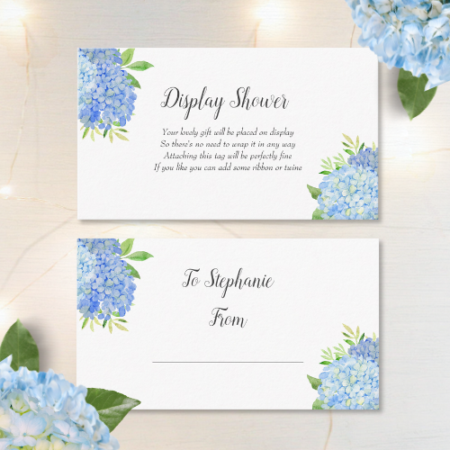 Blue hydrangea bridal shower display shower cards with modern watercolor blue hydrangea bouquet with foliage and script typography.