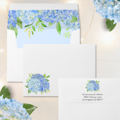 Blue hydrangea bridal shower invitation envelope with modern watercolor blue hydrangea bouquet with foliage and script typography.