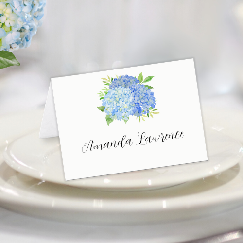 Blue hydrangea bridal shower folded personalized name place card with modern watercolor blue hydrangea bouquet with foliage and script typography.