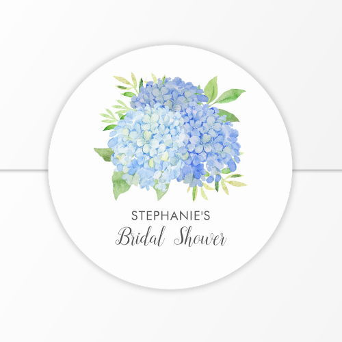 Blue hydrangea bridal shower round sticker on envelope with modern watercolor blue hydrangea bouquet with foliage and script typography.