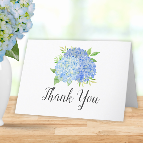 Blue hydrangea bridal shower folded thank you card with modern watercolor blue hydrangea bouquet with foliage and script typography.