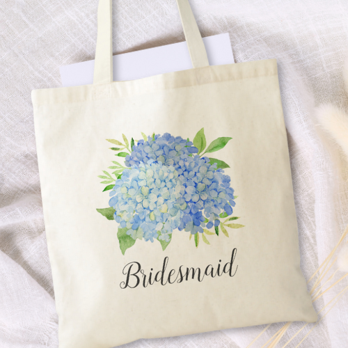 Blue hydrangea bridal shower bridesmaid tote bag with modern watercolor blue hydrangea bouquet with foliage and script typography.