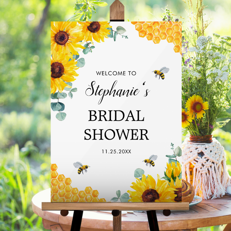 Acrylic bridal shower welcome sign with watercolor honeycomb, bees, sunflowers and eucalyptus foliage.