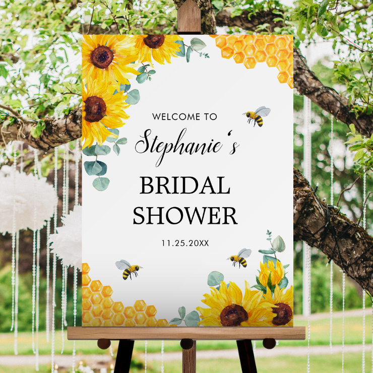 Bridal shower welcome sign foam board with watercolor honeycomb, bees, sunflowers and eucalyptus foliage.