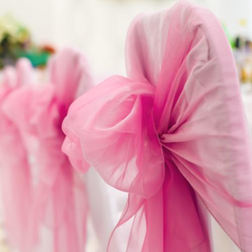 Coquette bridal shower theme inspiration image of pink organza bow chair sash.