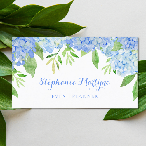 Event planner business cards with modern watercolor blue hydrangea and greenery floral botanical design and modern script typography font in blue.