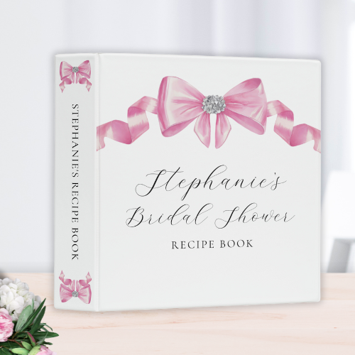 Shes tying the knot bridal shower coquette themed bridal shower recipe binder featuring a chic glam silky pink bow with sparkling rhinestones design and modern customizable script typography.