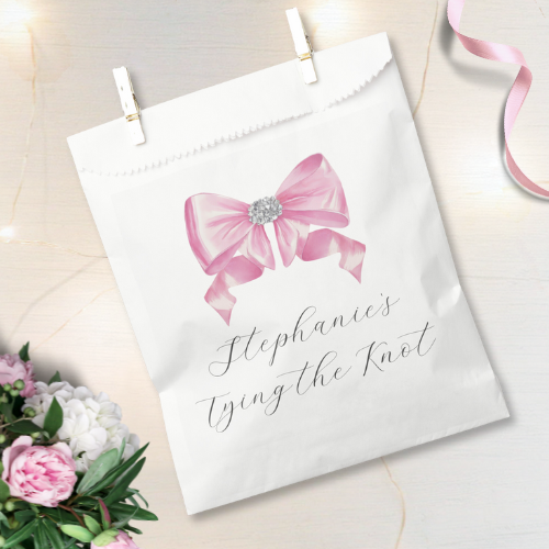 Shes tying the knot bridal shower coquette themed favor bag featuring a chic glam silky pink bow with sparkling rhinestones design and customizable modern script typography.