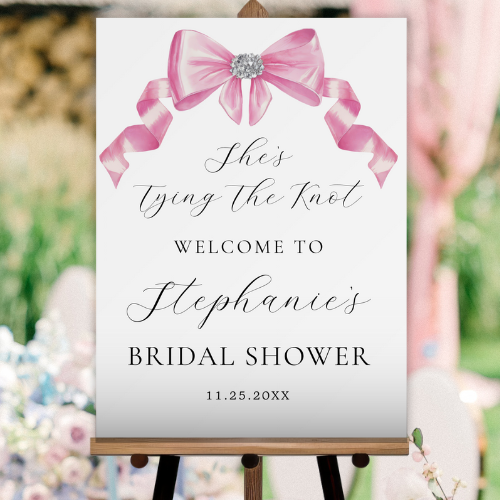 Shes tying the knot bridal shower coquette themed welcome sign featuring a chic glam silky pink bow with sparkling rhinestones design and modern script typography.