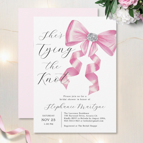 Shes Tying The Knot bridal shower invitations with a chic glam silky bow design coquette style with rhinestones and modern script typography customizable text.