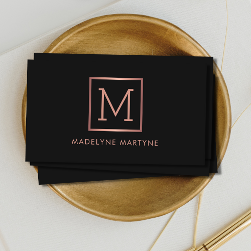 Classy minimal black business cards with rose gold style monogram logo in clean modern typography font.