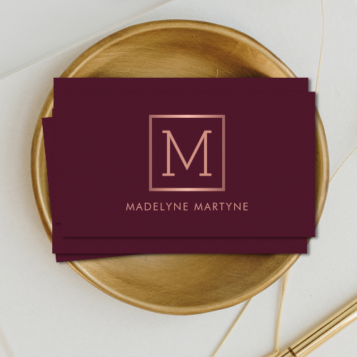 Elegant classy minimalist burgundy business cards with rose gold style monogram logo in clean modern typography font.