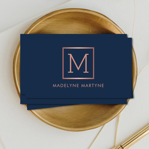 Elegant classy minimalist navy blue business cards with rose gold style monogram logo in clean modern typography font.